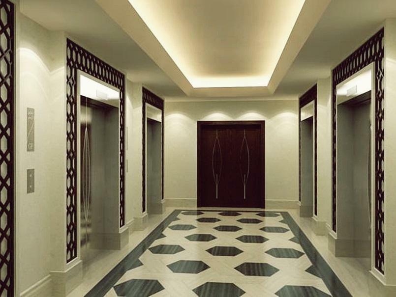 Jabal Omar Hyatt Regency Makkah Hotel Mecca Exterior foto The photo shows a modern, elegantly designed hotel hallway. It features a symmetrical layout with two sets of elevators on either side. The walls are a soft cream color, which enhances the overall brightness of the space. A sophisticated pattern can 